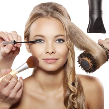 Professional makeup artist and hairdresser are preparing a fashion model. Portrait of beautiful blonde girl with blue eyes.
Isolated on white background